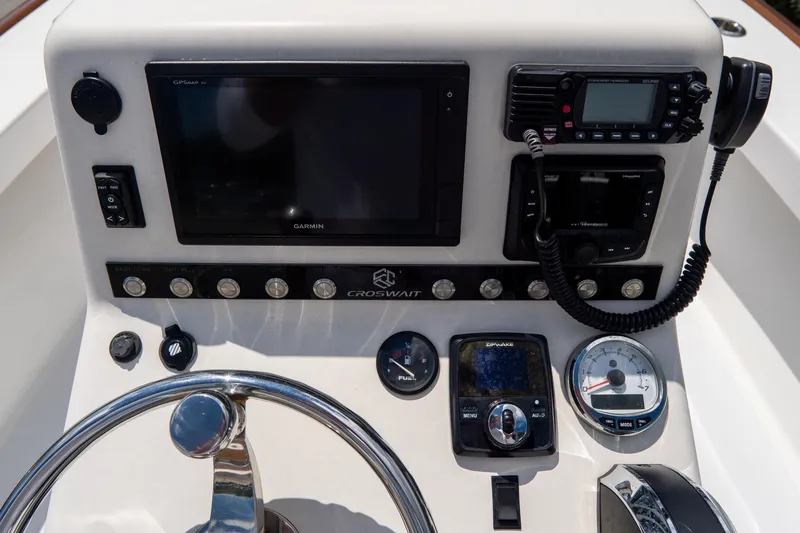 Slide: The Image of Control panel of 2022 Croswait Custom Carolina 21 boat with navigation and communication equipment. - 24