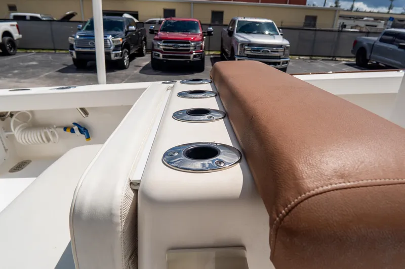 Slide: The Image of 2022 Croswait Custom Carolina 21 boat interior with rod holders and cushioned seating. - 25