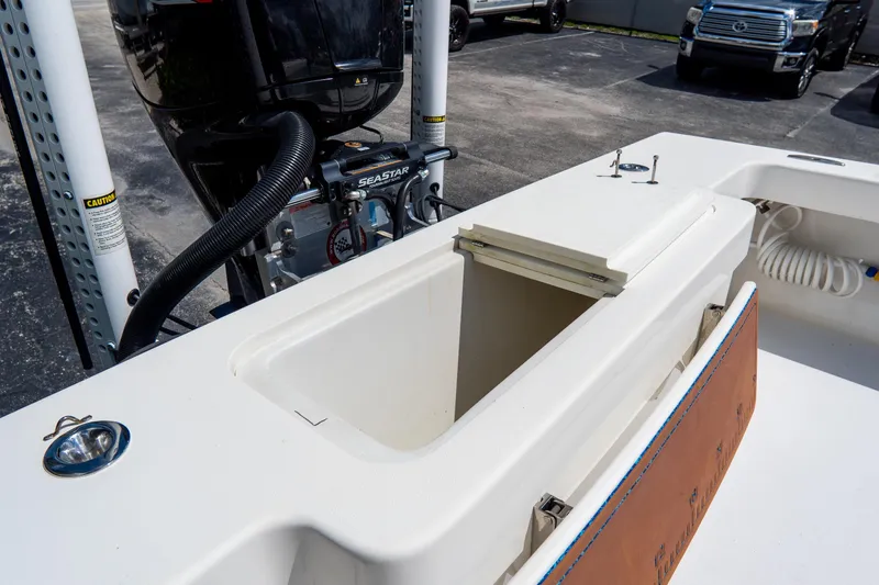 Slide: The Image of 2022 Croswait Custom Carolina 21 boat interior with storage compartment and motor. - 28