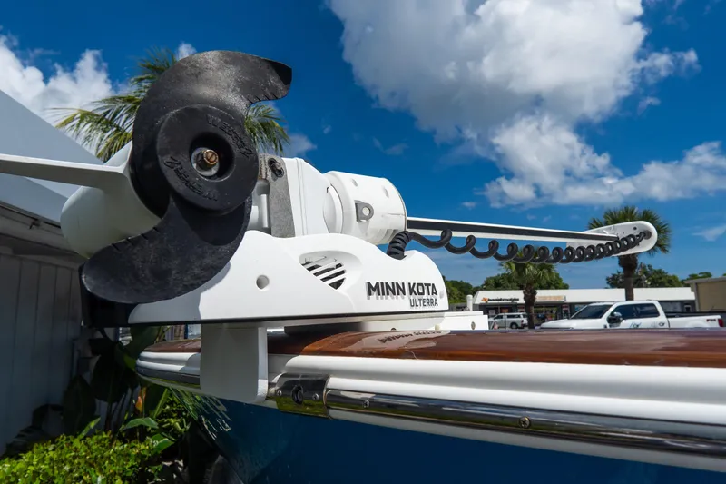 Slide: The Image of Minn Kota Ulterra motor on 2022 Croswait Custom Carolina 21 boat under blue sky. - 3