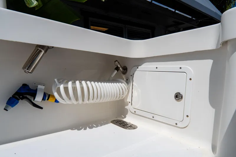 Slide: The Image of Croswait Custom Carolina 21 boat interior detail with coiled hose and storage compartment, 2022 model. - 34