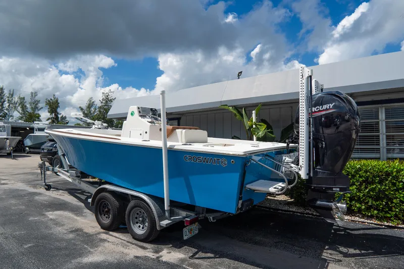 Slide: The Image of 2022 Croswait Custom Carolina 21 boat with Mercury engine on trailer, parked outdoors. - 4