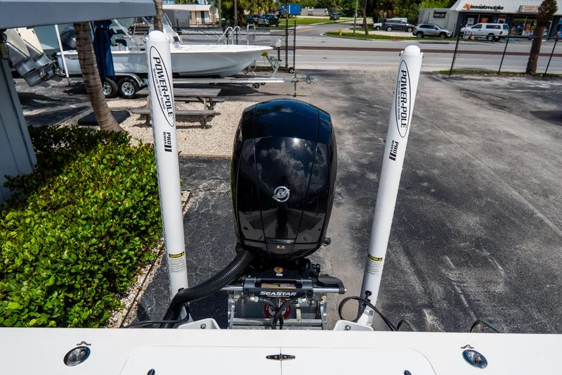 Slide: The Image of 2022 Croswait Custom Carolina 21 boat with Power-Pole anchors and outboard motor in a parking lot. - 8