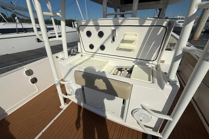 Slide: The Image of 2020 Everglades 435 Center Console boat cruising on open water, clear sky. - 11