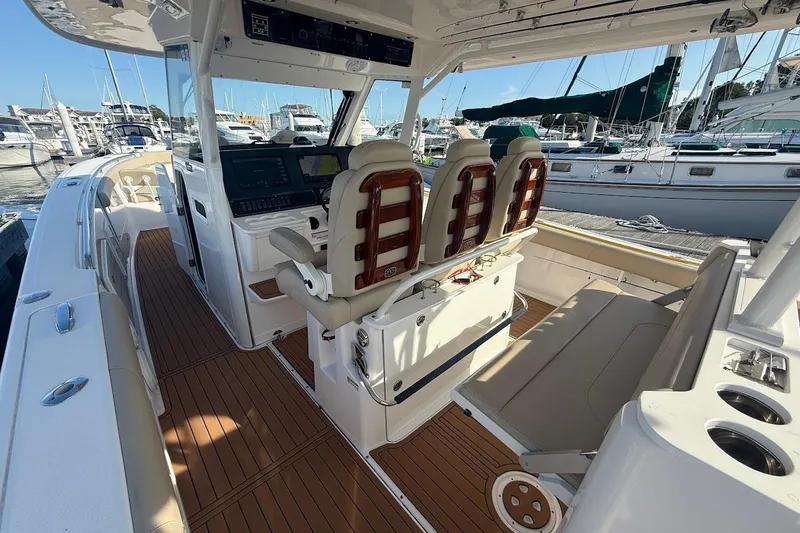 Slide: The Image of 2020 Everglades 435 Center Console boat on open water, featuring spacious deck and seating. - 12