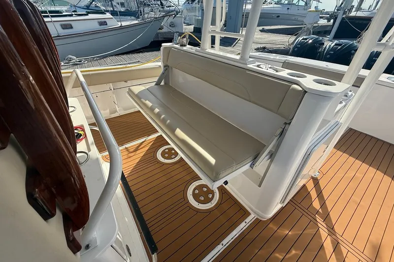 Slide: The Image of 2020 Everglades 435 Center Console boat interior with teak flooring and helm station. - 13