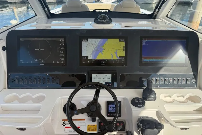 Slide: The Image of 2020 Everglades 435 Center Console dashboard with navigation and control screens. - 17