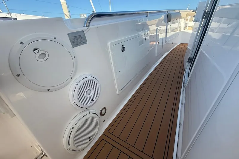 Slide: The Image of 2020 Everglades 435 Center Console cabin with bed, TV, and kitchenette. - 19