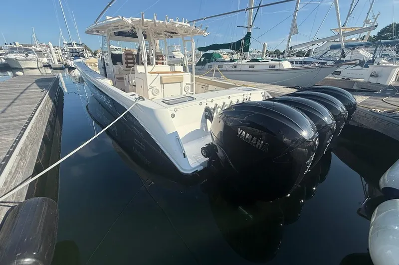 Slide: The Image of 2020 Everglades 435 Center Console boat with four powerful engines on open water. - 2