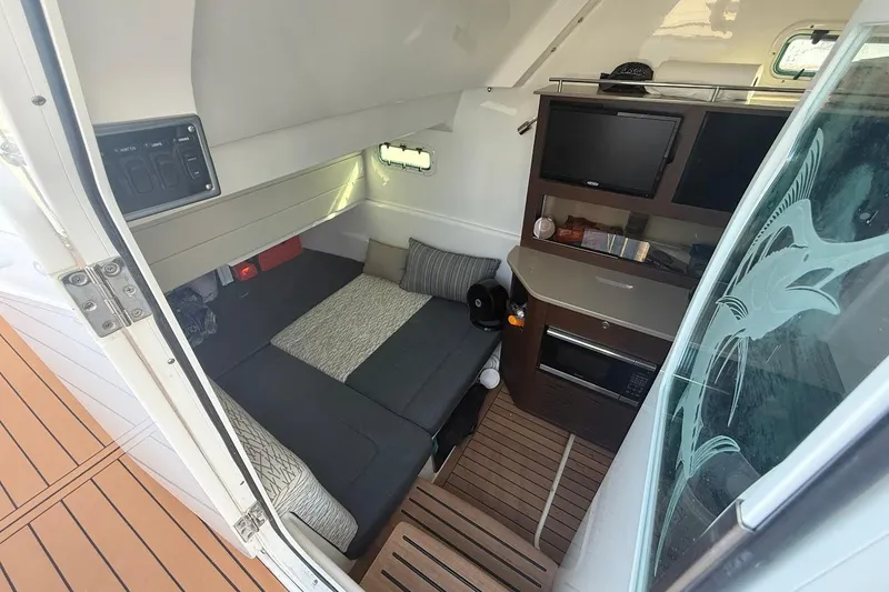 Slide: The Image of 2020 Everglades 435 Center Console boat interior with compact bathroom and toilet. - 21
