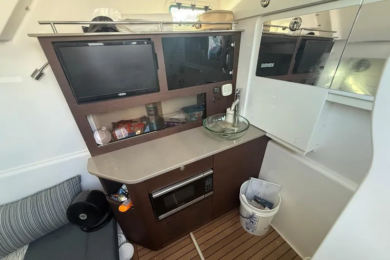 Slide: The Image of 2020 Everglades 435 Center Console boat with beige seating, cruising on a sunny day. - 23