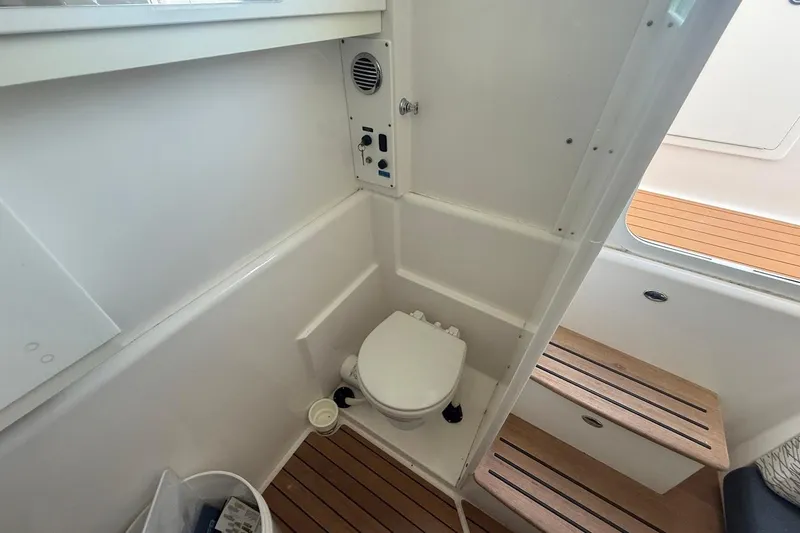 Slide: The Image of 2020 Everglades 435 Center Console boat interior with cushioned seating and ocean view. - 24
