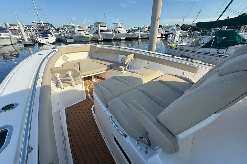 Slide: The Image of 2020 Everglades 435 Center Console boat with luxurious seating on calm waters. - 25