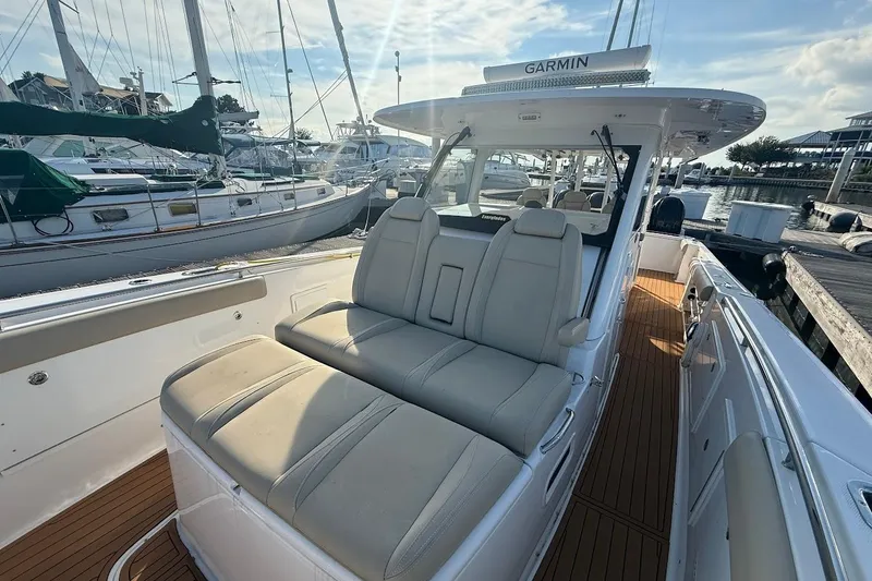 Slide: The Image of 2020 Everglades 435 Center Console cruising on open water, showcasing luxury seating and sleek design. - 26