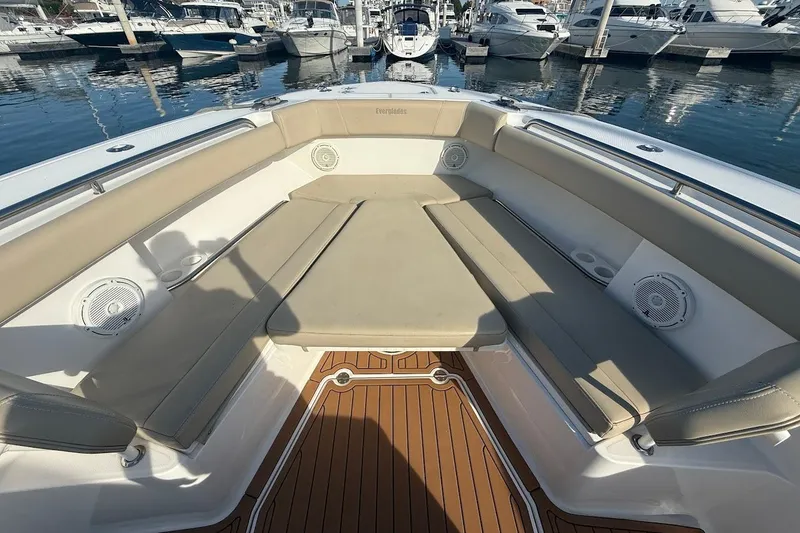 Slide: The Image of 2020 Everglades 435 Center Console boat docked with triple Yamaha engines. - 27
