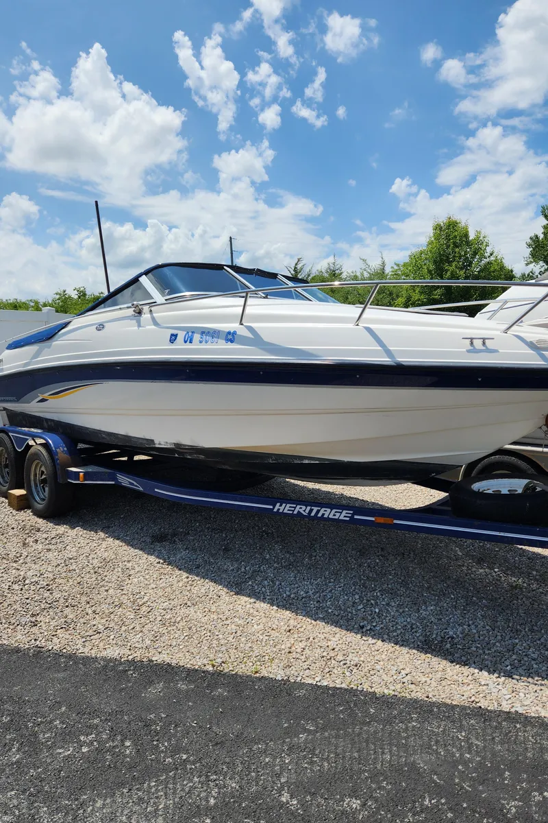 Slide: The Image of 2000 Chaparral 200SSI boat on a trailer under a blue sky. - 10