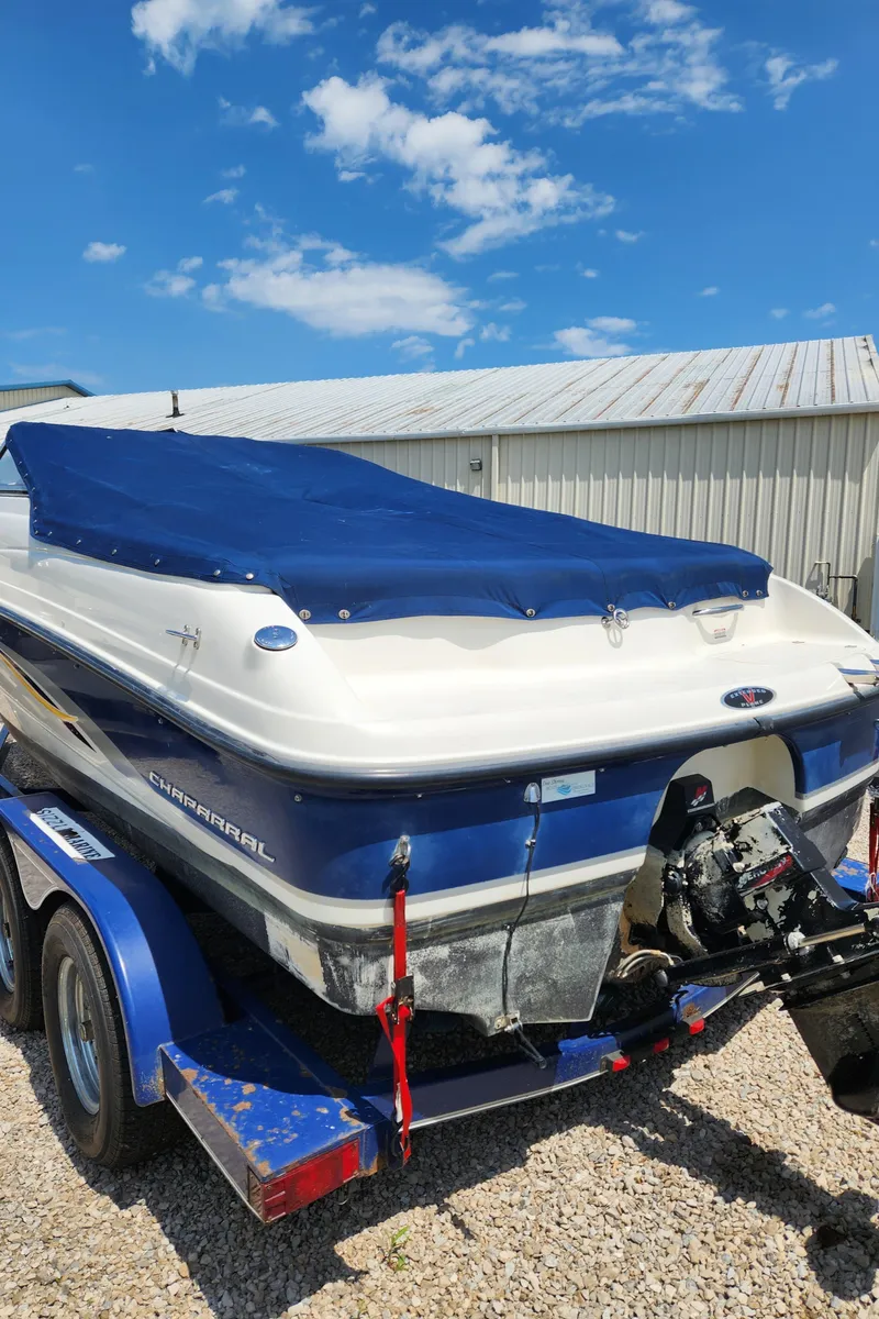 Slide: The Image of 2000 Chaparral 200SSI boat with blue cover on trailer. - 6