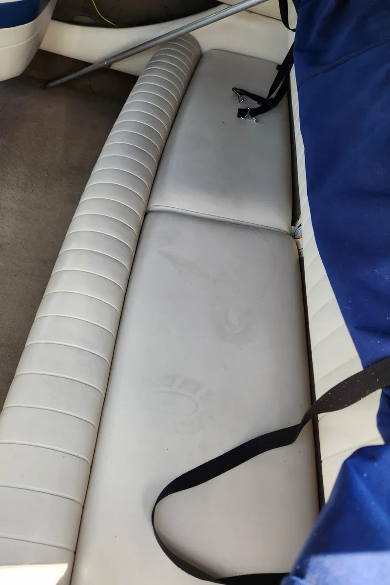 Slide: The Image of Interior seating of 2000 Chaparral 200SSI boat with white upholstery and blue cover. - 9