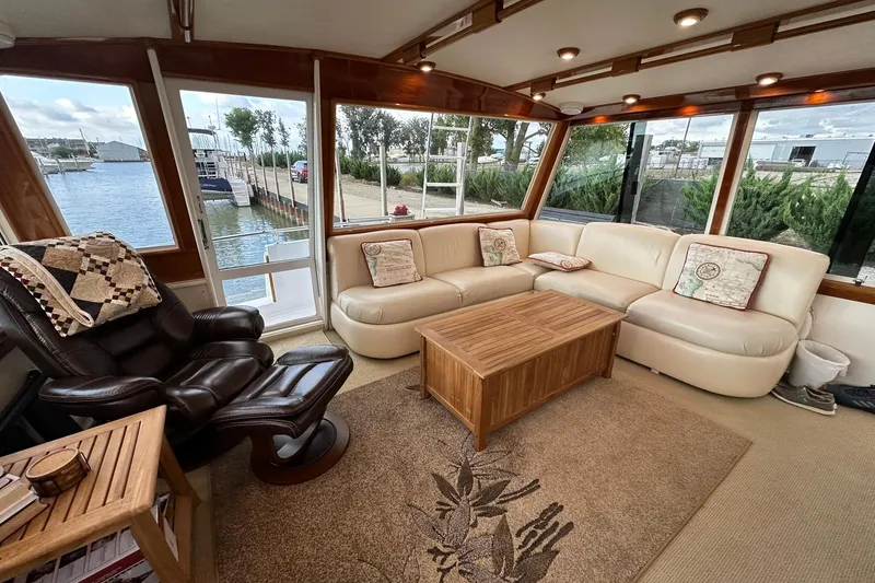 Slide: The Image of Luxurious interior of a 1998 Viking 54 Motor Yacht with leather seating and panoramic windows. - 10