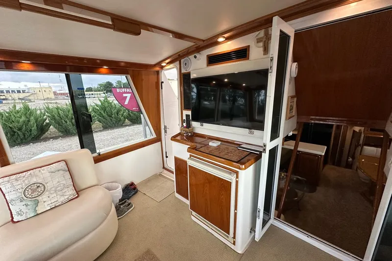 Slide: The Image of Interior of 1998 Viking 54 Motor Yacht with TV, seating, and window view. - 11