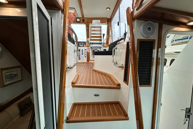 Slide: The Image of Interior view of 1998 Viking 54 Motor Yacht with wooden stairs and seating area. - 13