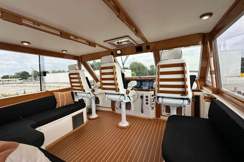 Slide: The Image of Interior of 1998 Viking 54 Motor Yacht with helm chairs and seating area. - 14