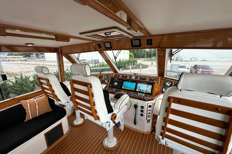 Slide: The Image of Interior of 1998 Viking 54 Motor Yacht with helm, navigation screens, and seating. - 15