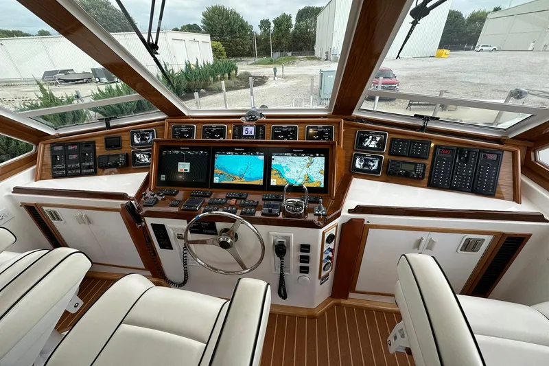 Slide: The Image of Cockpit of 1998 Viking 54 Motor Yacht with navigation screens and controls. - 16