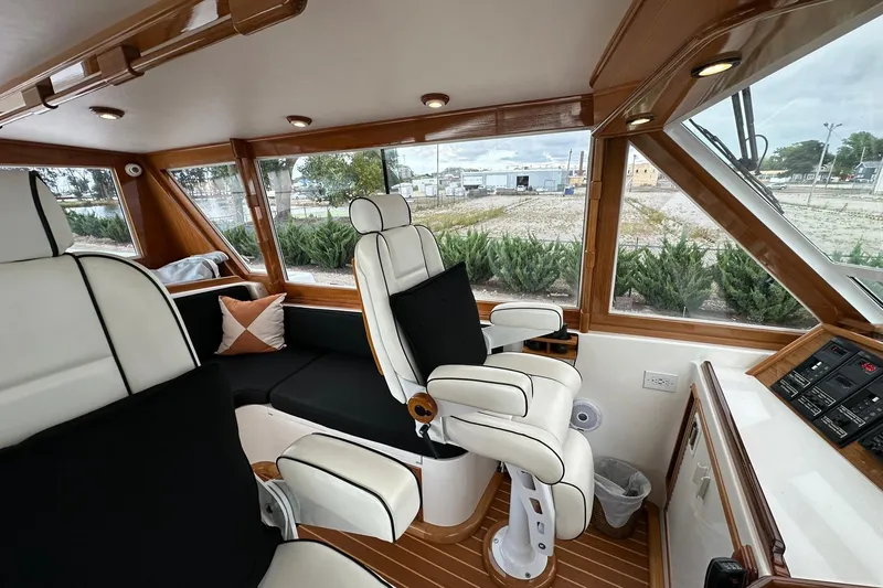 Slide: The Image of Luxurious interior of a 1998 Viking 54 Motor Yacht with plush seating and panoramic windows. - 18
