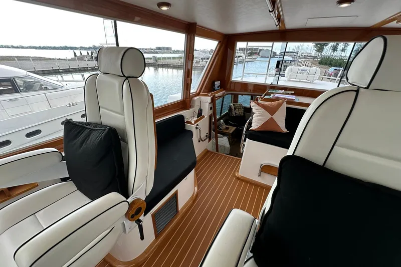 Slide: The Image of Interior of 1998 Viking 54 Motor Yacht with luxurious seating and wood accents. - 19