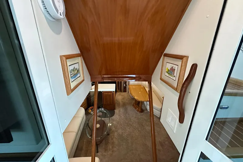 Slide: The Image of Interior view of 1998 Viking 54 Motor Yacht with wooden accents and framed artwork. - 21