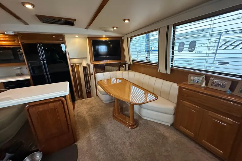 Slide: The Image of Luxurious interior of a 1998 Viking 54 Motor Yacht with elegant dining area and modern amenities. - 24