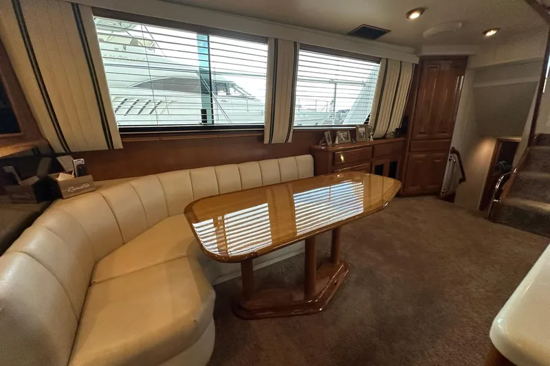 Slide: The Image of Interior of 1998 Viking 54 Motor Yacht with elegant seating and wooden table. - 25