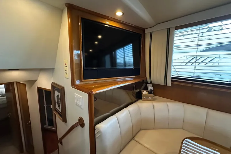Slide: The Image of Interior of 1998 Viking 54 Motor Yacht with TV and seating area. - 26
