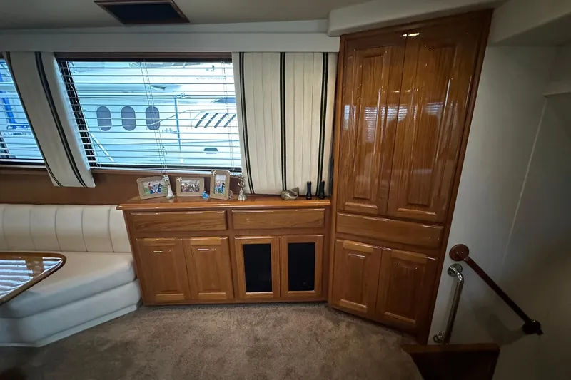 Slide: The Image of Interior of 1998 Viking 54 Motor Yacht with wood cabinetry and large windows. - 27