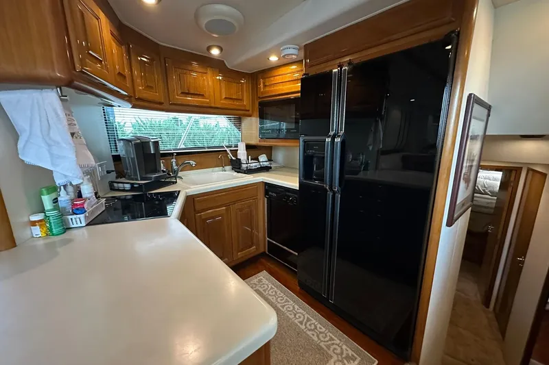 Slide: The Image of 1998 Viking 54 Motor Yacht kitchen with wooden cabinets and modern appliances. - 28