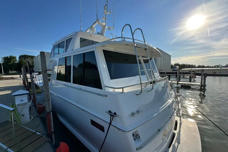 Slide: The Image of 1998 Viking 54 Motor Yacht docked, sunlit, with sleek design and modern features. - 3