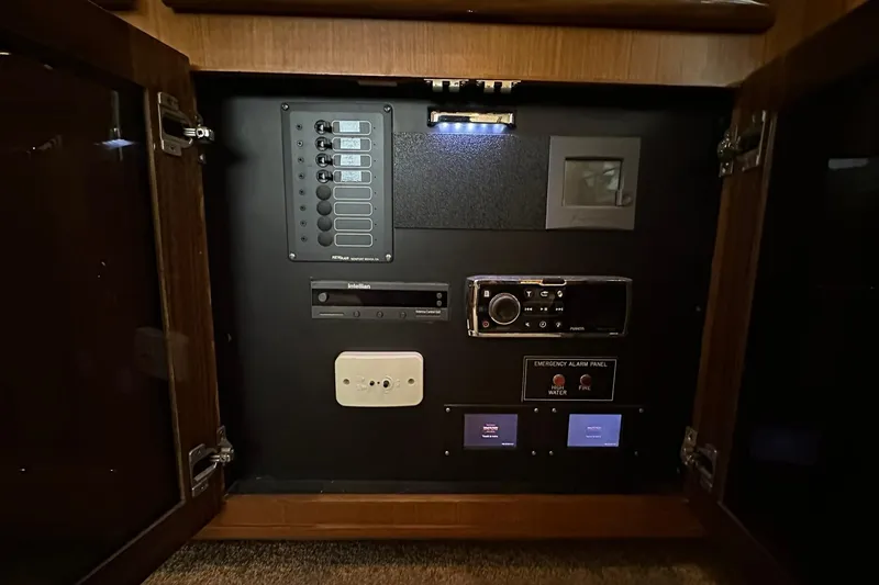 Slide: The Image of Control panel inside 1998 Viking 54 Motor Yacht, featuring various switches and emergency alarm system. - 31