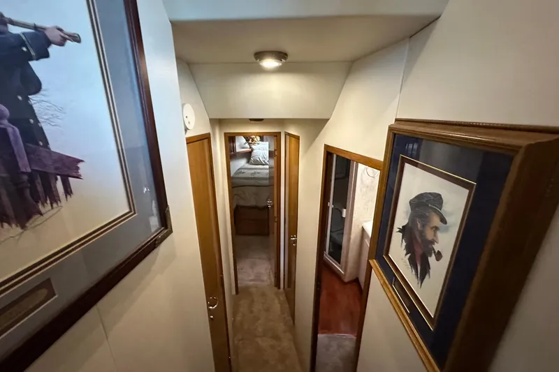 Slide: The Image of Hallway inside 1998 Viking 54 Motor Yacht with framed nautical artwork. - 32