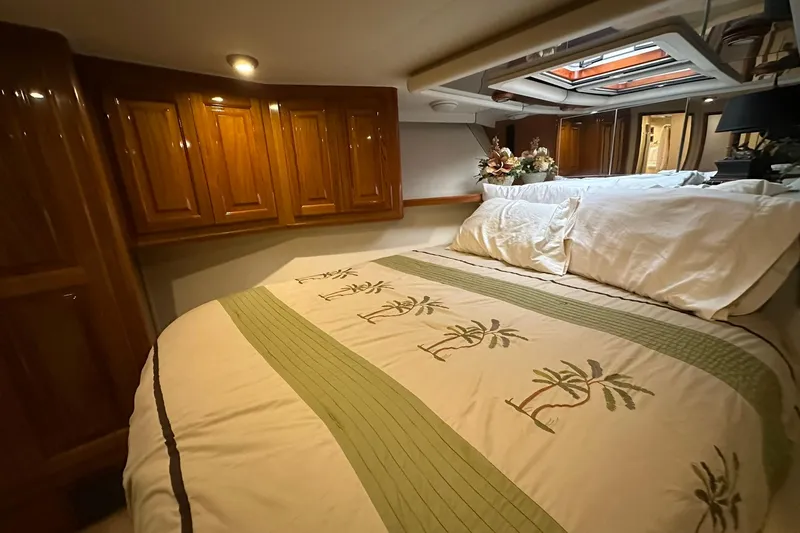 Slide: The Image of Luxurious bedroom interior of 1998 Viking 54 Motor Yacht with elegant wood cabinetry. - 35