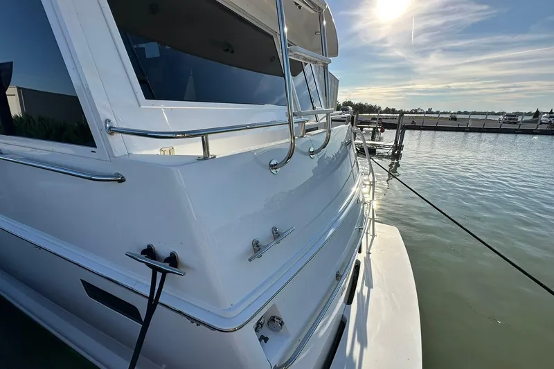 Slide: The Image of 1998 Viking 54 Motor Yacht docked under sunny skies. - 4