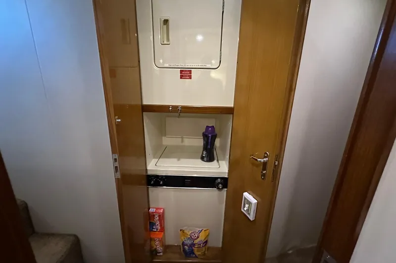 Slide: The Image of Laundry area inside 1998 Viking 54 Motor Yacht with stacked washer and dryer. - 41