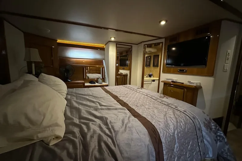 Slide: The Image of Luxurious bedroom interior of 1998 Viking 54 Motor Yacht with TV and elegant decor. - 42