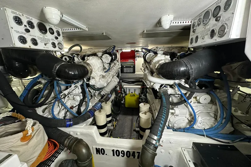 Slide: The Image of Engine room of a 1998 Viking 54 Motor Yacht, showcasing dual engines and control panels. - 46