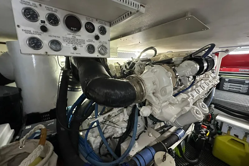 Slide: The Image of Engine room of a 1998 Viking 54 Motor Yacht, showcasing detailed machinery and control panel. - 47