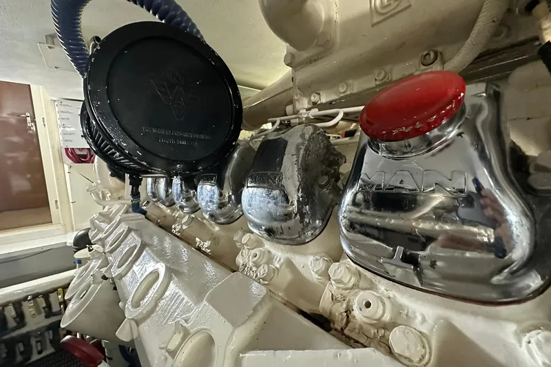 Slide: The Image of Engine room of a 1998 Viking 54 Motor Yacht, featuring MAN engine components. - 54