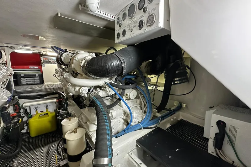 Slide: The Image of Engine room of 1998 Viking 54 Motor Yacht, showcasing mechanical components and control panel. - 55