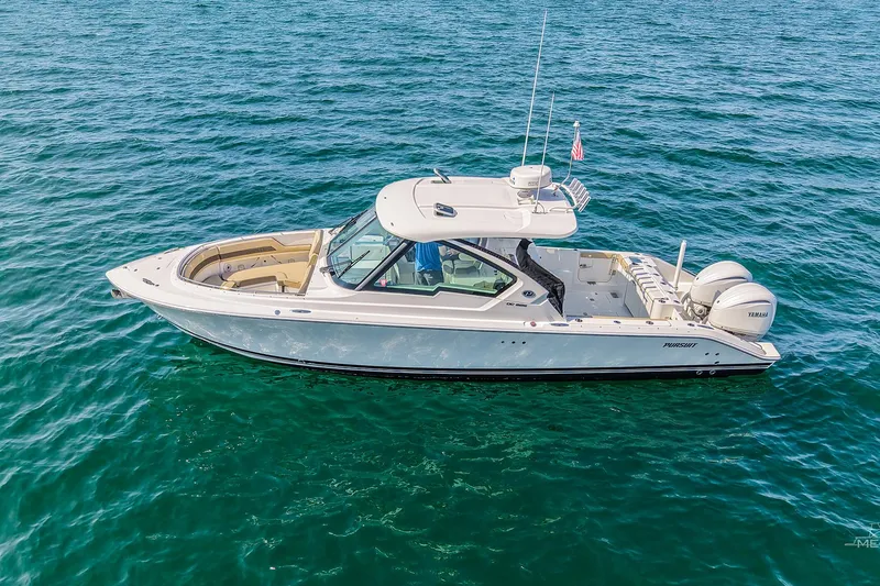 The Image of 2021 Pursuit DC 326 Dual Console boat on open water, side view. - 0