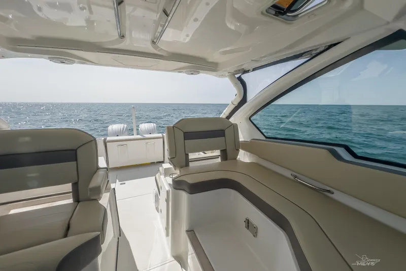 Slide: The Image of Interior view of 2021 Pursuit DC 326 Dual Console boat on open sea. - 10