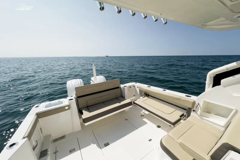 Slide: The Image of 2021 Pursuit DC 326 Dual Console boat on open sea, spacious deck view. - 12